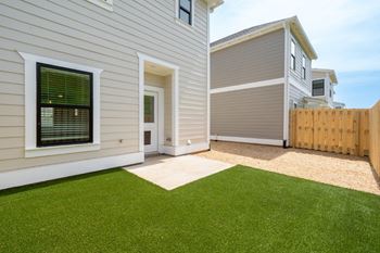 A house with a green lawn in front.